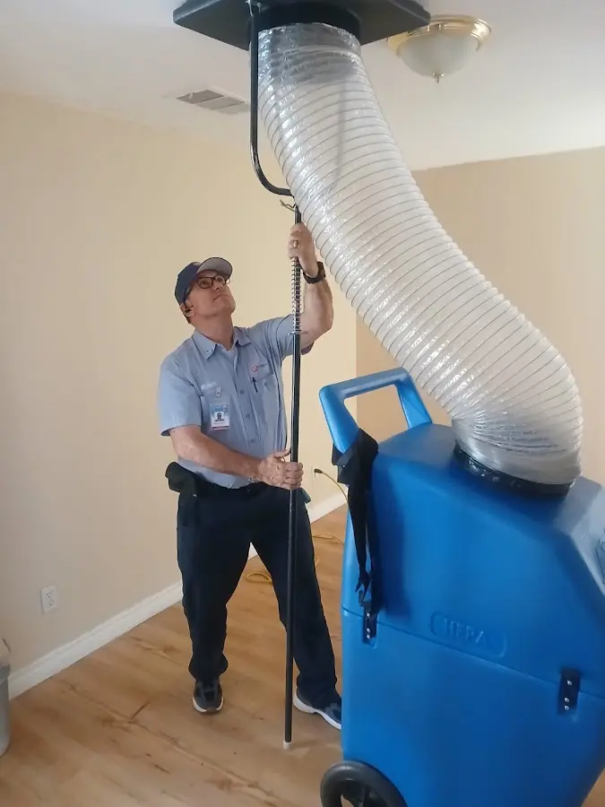 Furnace Tune-Up technician using HEPA equipment in Saraland
